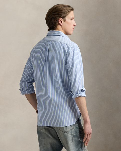 The oxford shirt made its debut very early in Ralph Lauren Lauren’s designs, and since then, it has solidified its status as a pillar of the Polo look. Our fabric is developed with a secret wash, which gives it instant character, ease and a heathered softness. The formula is so unique that it's been kept in a safe for more than three decades. In addition to details evoking its prep-school inspiration, it offers a relaxed feel, producing what we refer to as "the perfect rumple." Today, Mr Lauren continues to create countless variations of his iconic shirt, including this striped version that is finished with our signature embroidered Pony.