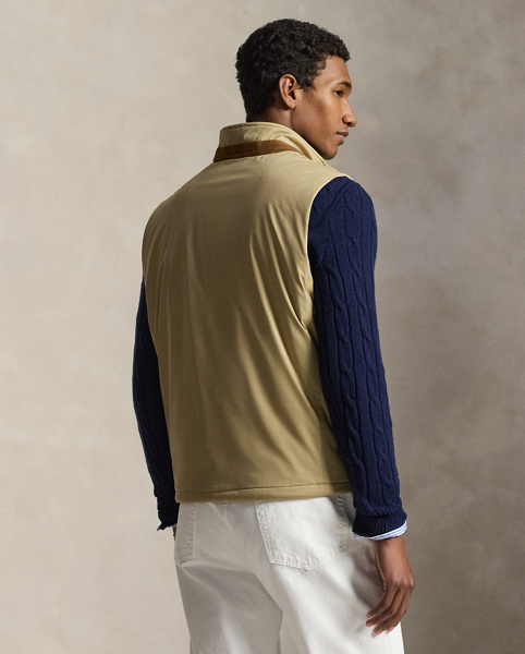 This gilet is crafted from water-resistant twill and insulated with ultra-lightweight down-alternative fill. Thoughtfully constructed, it features suede and leather details as well as a comfortable stretch jersey lining.