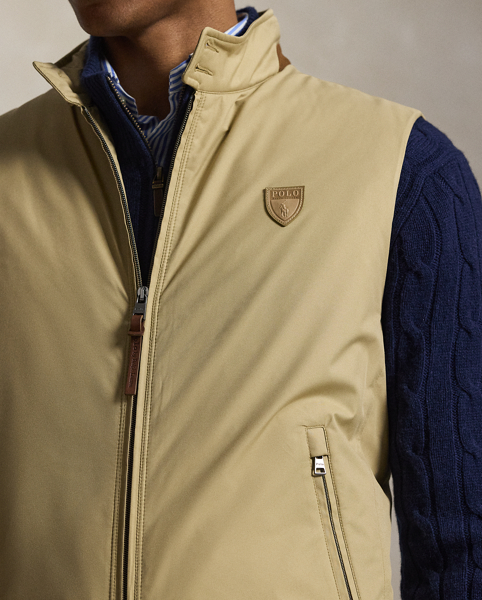 This gilet is crafted from water-resistant twill and insulated with ultra-lightweight down-alternative fill. Thoughtfully constructed, it features suede and leather details as well as a comfortable stretch jersey lining.