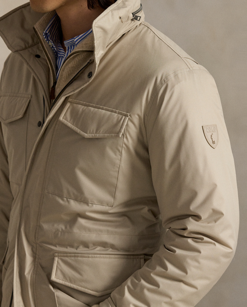 This jacket is crafted from water-resistant twill and insulated with ultra-lightweight down-alternative fill. Thoughtfully constructed, it features a stowaway hood and comfortable stretch jersey lining.