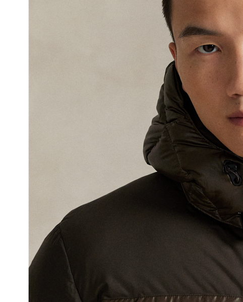 Made from water-repellent fabric, this jacket is insulated with 650-fill-power down and constructed with a detachable hood. A tonal combination of matted and glossed panels provides a modern take on texture.