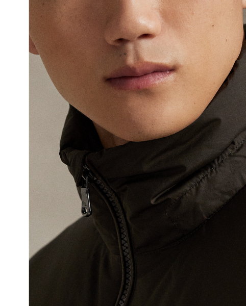 Made from water-repellent fabric, this jacket is insulated with 650-fill-power down and constructed with a detachable hood. A tonal combination of matted and glossed panels provides a modern take on texture.