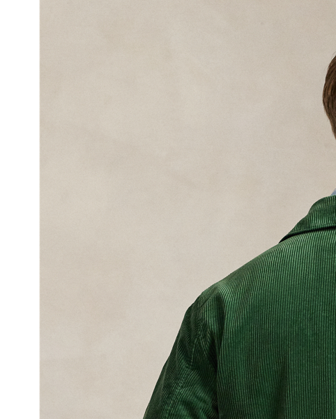 This cotton jacket contrasts the sporty silhouette of a windbreaker with the rustic texture of wide-wale corduroy. It is dyed in a custom-developed colour and finished with considered details, such as tartan-inspired lining and leather accents.