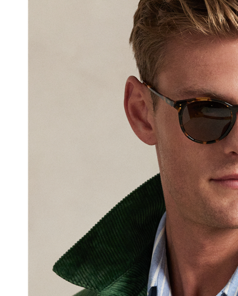 This cotton jacket contrasts the sporty silhouette of a windbreaker with the rustic texture of wide-wale corduroy. It is dyed in a custom-developed colour and finished with considered details, such as tartan-inspired lining and leather accents.