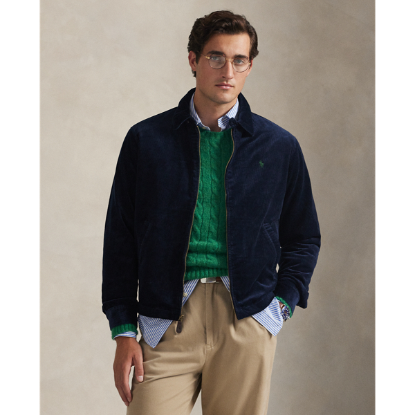 This cotton jacket contrasts the sporty silhouette of a windbreaker with the rustic texture of wide-wale corduroy. It is dyed in a custom-developed colour and finished with considered details, such as tartan-inspired lining and leather accents.