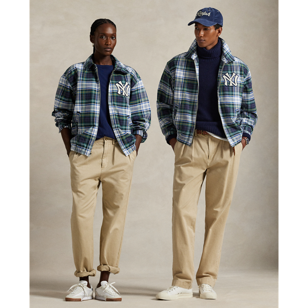 As a boy growing up in the Bronx, Mr Lauren loved going to Yankee Stadium™ to watch his hometown heroes play ball. This plaid unisex jacket celebrates Mr Lauren's long-standing love of the Bronx Bombers™ and the game of baseball with a New York Yankees™ logo patch. Finished with " Ralph Lauren Lauren" embroidery, it playfully combines the silhouette of a windbreaker with classic oxford cloth.