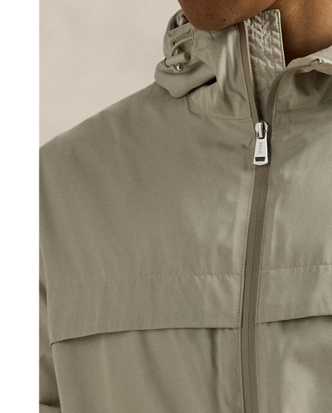 Crafted from water-repellent fabric, this jacket features functional details, such as a mesh-lined vented back and metal grommets on the underarms for breathability.