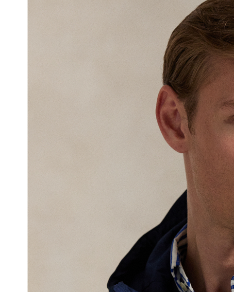 Crafted from water-repellent fabric, this jacket features functional details, such as a mesh-lined vented back and metal grommets on the underarms for breathability.