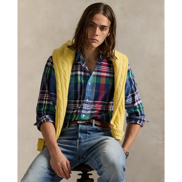 The oxford shirt made its debut very early in Ralph Lauren Lauren’s designs, and since then, it has solidified its status as a pillar of the Polo look. Our fabric is developed with a secret wash, giving it instant character, ease and a heathered softness – what we refer to as "the perfect rumple". The formula is so unique that it's been kept in a safe for more than three decades. Today, Mr Lauren continues to create countless variations of his iconic shirt, including this plaid version, which is finished with our signature embroidered Pony.