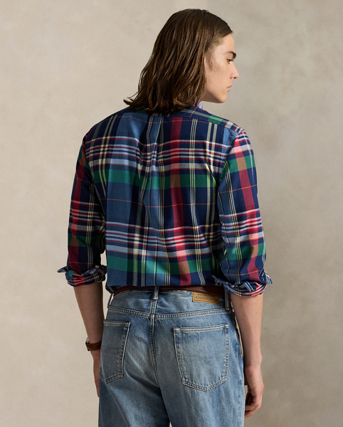 The oxford shirt made its debut very early in Ralph Lauren Lauren’s designs, and since then, it has solidified its status as a pillar of the Polo look. Our fabric is developed with a secret wash, giving it instant character, ease and a heathered softness – what we refer to as "the perfect rumple". The formula is so unique that it's been kept in a safe for more than three decades. Today, Mr Lauren continues to create countless variations of his iconic shirt, including this plaid version, which is finished with our signature embroidered Pony.