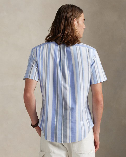 The oxford shirt made its debut very early in Ralph Lauren Lauren’s designs, and since then, it has solidified its status as a pillar of the Polo look. Our fabric is developed with a secret wash, which gives it instant character, ease and a heathered softness. The formula is so unique that it's been kept in a safe for more than three decades. In addition to details evoking its prep-school inspiration, it offers a relaxed feel, producing what we refer to as "the perfect rumple." Today, Mr Lauren continues to create countless variations of his iconic shirt, including this striped version, which is finished with our signature embroidered Pony.