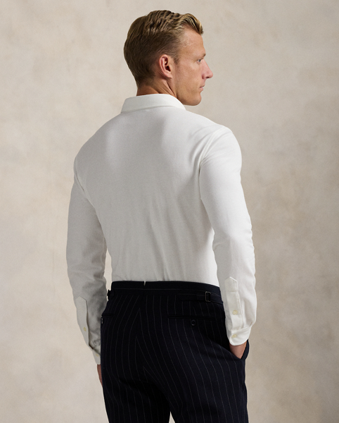 Part of our collection celebrating Wimbledon 2025, this unisex Polo shirt is embroidered with the tournament's logo and location, which includes its "SW19" postcode. Our signature embroidered Pony and genuine mother-of-pearl buttons adorn this cotton mesh style.