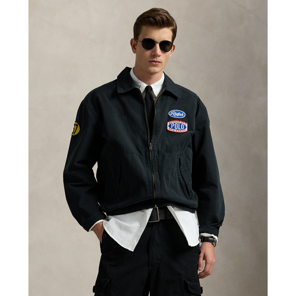 Part of the season's motorsport-inspired collection, this jacket features a " Ralph Lauren's Garage" graphic, which originally debuted at the 2017 runway show held at Mr Lauren's personal garage in New York. A special wash gives the canvas layer a timeworn appearance, while signature patches make it purely Polo.