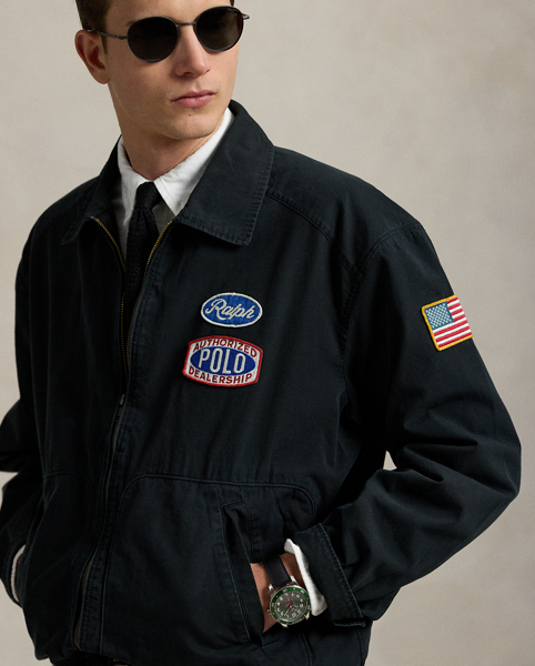 Part of the season's motorsport-inspired collection, this jacket features a " Ralph Lauren's Garage" graphic, which originally debuted at the 2017 runway show held at Mr Lauren's personal garage in New York. A special wash gives the canvas layer a timeworn appearance, while signature patches make it purely Polo.