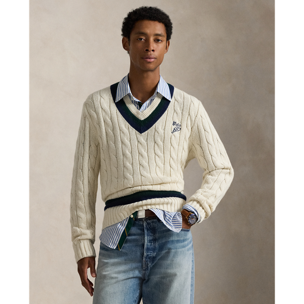 The cricket jumper is defined by its cable-knit pattern, usually in cream, as well as its V-neck and striped trim, which traditionally represents school or club colours.  Ralph Lauren Lauren introduced his version in 1972, and this updated take combines the iconic characteristics with a cotton blend that includes cashmere and hemp. At the front, it is embroidered with an athletic-inspired graphic that incorporates Polo's founding year.