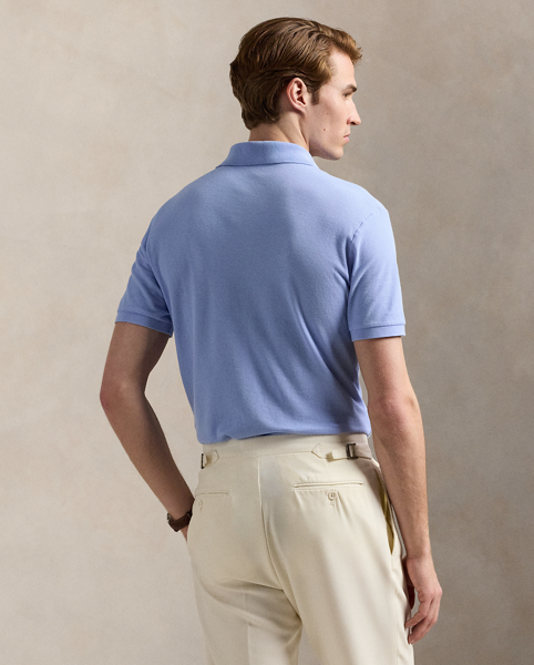 An American style standard since 1972, the Polo shirt has been imitated but never matched. Over the decades, Ralph Lauren Lauren has reimagined his signature style in a wide array of colours and fits, yet all retain the quality and attention to detail of the iconic original. This version is made with honeycomb-textured cotton mesh and finished with genuine mother-of-pearl buttons.