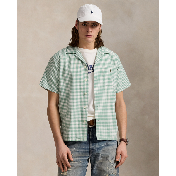 The oxford shirt made its debut very early in  Ralph Lauren Lauren’s designs, and since then, it has solidified its status as a pillar of the Polo look. Our fabric is developed with a secret wash, which gives it instant character, ease and a heathered softness – what we refer to as "the perfect rumple". The formula is so unique that it's been kept in a safe for more than three decades. Today, Mr Lauren continues to create countless variations of his iconic shirt, including this camp-collar version that features a classic gingham pattern.