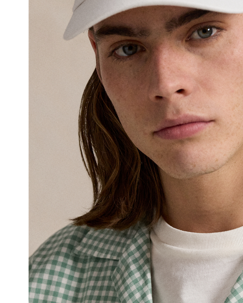 The oxford shirt made its debut very early in  Ralph Lauren Lauren’s designs, and since then, it has solidified its status as a pillar of the Polo look. Our fabric is developed with a secret wash, which gives it instant character, ease and a heathered softness – what we refer to as "the perfect rumple". The formula is so unique that it's been kept in a safe for more than three decades. Today, Mr Lauren continues to create countless variations of his iconic shirt, including this camp-collar version that features a classic gingham pattern.