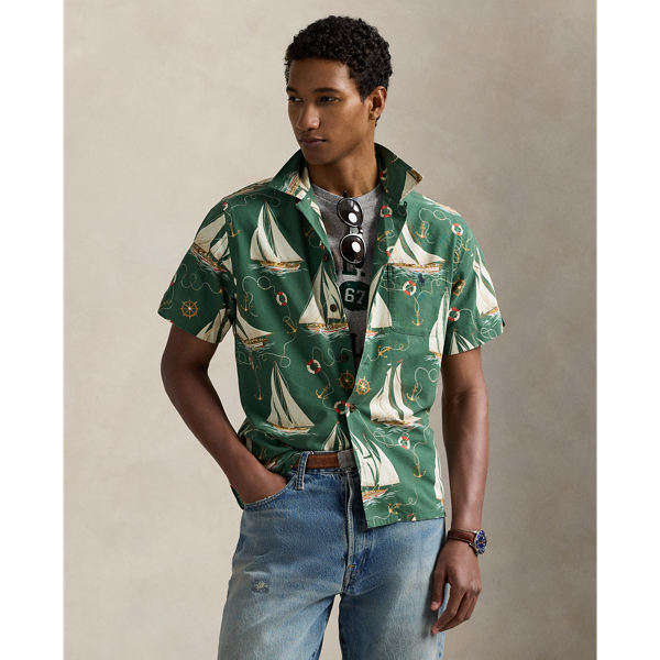 The oxford shirt made its debut very early in  Ralph Lauren Lauren’s designs, and since then, it has solidified its status as a pillar of the Polo look. Our fabric is developed with a secret wash, which gives it instant character, ease and a heathered softness – what we refer to as "the perfect rumple". The formula is so unique that it's been kept in a safe for more than three decades. Today, Mr Lauren continues to create countless variations of his iconic shirt, including this camp-collar version. It features an archival  Ralph Lauren Lauren print from the early aughts: a sailboat motif inspired by mid-20th-century home furnishing patterns.