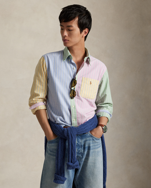 Decades ago, tailors would learn their craft by sewing together shirts made from fabric remnants. Over time, a staple of playful preppy style evolved from this practice – the fun shirt. This pastel-hued version combines four striped patterns into a single statement-making oxford and is adorned with the iconic multicoloured Pony.