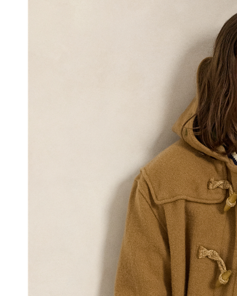 The cricket jumper is defined by its cable-knit pattern, usually in cream, as well as its V-neck and striped trim, which traditionally represents school or club colours. Part of the season's collection inspired by New England's storied regatta tradition, this version is embroidered with a signature crest and oars.