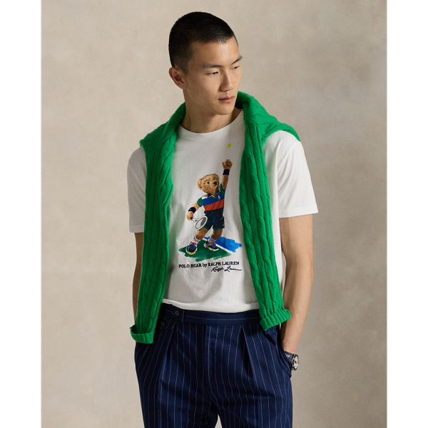 Celebrating Ralph Lauren Lauren's 20th anniversary in partnership with the US Open, this jersey T-shirt is part of our 2025 US Open Tennis Championships collection. It features our iconic Polo Bear dressed in the ball crew uniform designed by Ralph Lauren Lauren for this year's tournament. Embroidery along with flocked detailing on the tennis ball and the Polo Bear's wristbands add whimsical texture.