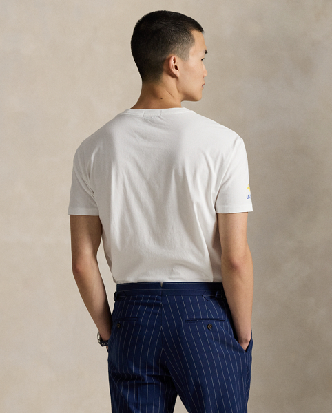 Celebrating Ralph Lauren Lauren's 20th anniversary in partnership with the US Open, this jersey T-shirt is part of our 2025 US Open Tennis Championships collection. It features our iconic Polo Bear dressed in the ball crew uniform designed by Ralph Lauren Lauren for this year's tournament. Embroidery along with flocked detailing on the tennis ball and the Polo Bear's wristbands add whimsical texture.