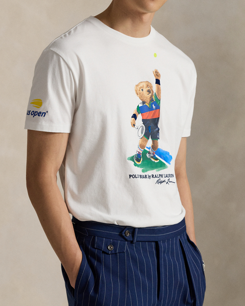 Celebrating Ralph Lauren Lauren's 20th anniversary in partnership with the US Open, this jersey T-shirt is part of our 2025 US Open Tennis Championships collection. It features our iconic Polo Bear dressed in the ball crew uniform designed by Ralph Lauren Lauren for this year's tournament. Embroidery along with flocked detailing on the tennis ball and the Polo Bear's wristbands add whimsical texture.