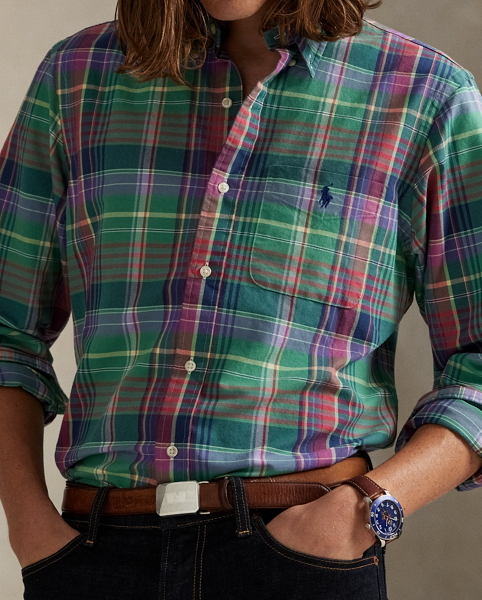 The oxford shirt made its debut very early in Ralph Lauren Lauren’s designs, and since then, it has solidified its status as a pillar of the Polo look. Our fabric is developed with a secret wash, giving it instant character, ease and a heathered softness – what we refer to as "the perfect rumple". The formula is so unique that it's been kept in a safe for more than three decades. Today, Mr Lauren continues to create countless variations of his iconic shirt, including this plaid version, which is finished with our signature embroidered Pony.