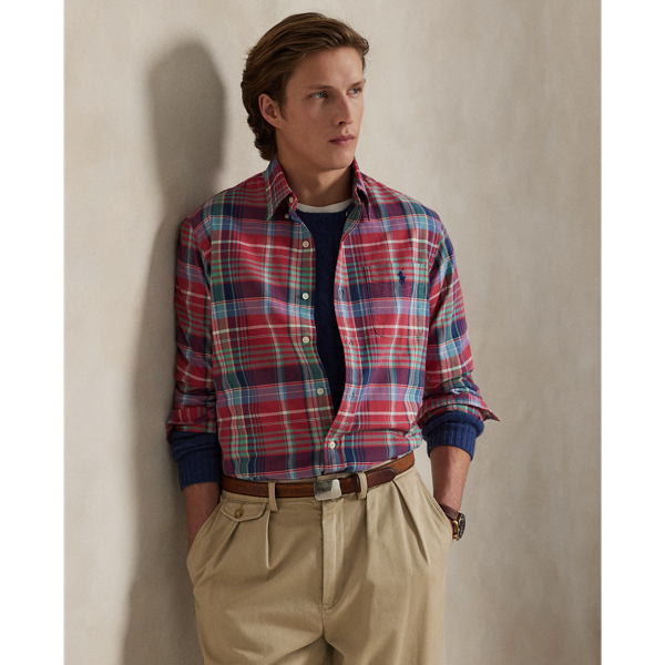The oxford shirt made its debut very early in  Ralph Lauren Lauren’s designs, and since then, it has solidified its status as a pillar of the Polo look. Our fabric is developed with a secret wash, giving it instant character, ease and a heathered softness – what we refer to as "the perfect rumple". The formula is so unique that it's been kept in a safe for more than three decades. Today, Mr Lauren continues to create countless variations of his iconic shirt, including this plaid version, which is finished with our signature embroidered Pony.