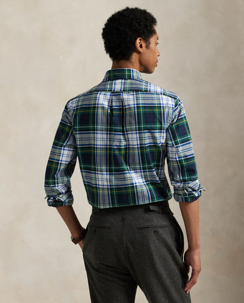 The oxford shirt made its debut very early in Ralph Lauren Lauren’s designs, and since then, it has solidified its status as a pillar of the Polo look. Our fabric is developed with a secret wash, giving it instant character, ease and a heathered softness – what we refer to as "the perfect rumple". The formula is so unique that it's been kept in a safe for more than three decades. Today, Mr Lauren continues to create countless variations of his iconic shirt, including this plaid version, which is finished with our signature embroidered Pony.