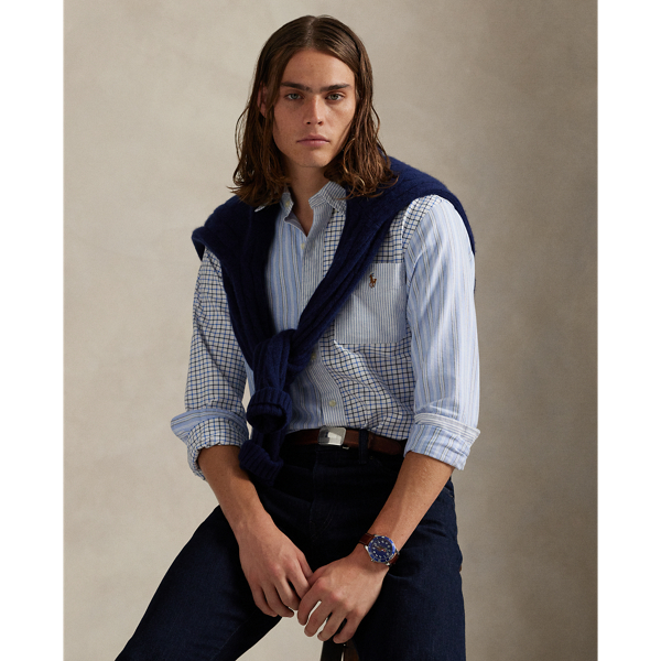 Decades ago, tailors would learn their craft by sewing together shirts made from fabric remnants. Over time, a staple of playful preppy style evolved from this practice – the fun shirt. This version combines contrasting stripes and tattersall into a single statement-making oxford, adorned with the iconic multicoloured Pony.