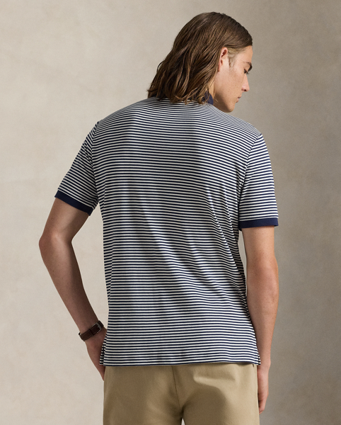 An American style standard since 1972, the Polo shirt has been imitated but never matched. Over the decades, Ralph Lauren Lauren has re-imagined his signature style in a wide array of colours and fits, yet all retain the quality and attention to detail of the iconic original. This striped version is made with luxe cotton interlock featuring an ultrasoft finish.