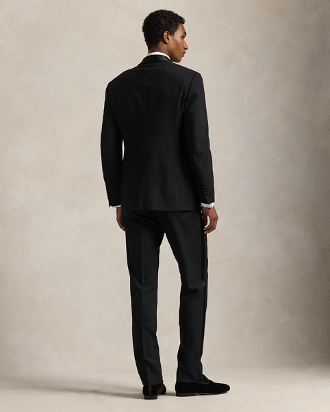 Our Polo tuxedo jacket offers more structure in the chest and shoulders along with full lining. This version, which is paired with double-pleated trousers, is tailored in Italy from custom-developed wool barathea cloth and finished with silk-blend trim.