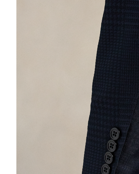 Our Polo jacket offers more structure in the chest and shoulders along with a full lining. This tuxedo version is meticulously tailored in Italy from a jacquard cloth that was woven with a tonal plaid motif. The luxurious fabric was custom-developed with a centuries-old English mill using a blend of silk, wool and cotton.