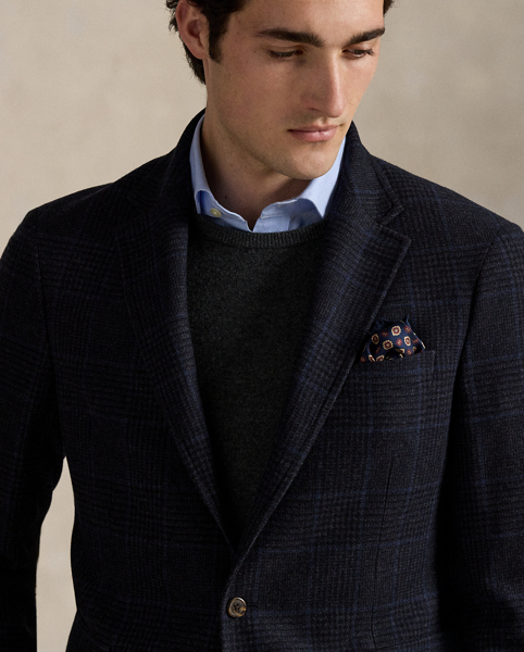 Our Polo sport coat offers more structure in the chest and shoulders along with full lining. This version is tailored with a custom-developed wool-blend cloth and features a classic Glen plaid pattern that is punctuated with a subtle blue overcheck.