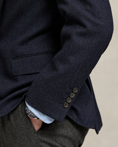 Our Polo sport coat offers more structure in the chest and shoulders along with full lining. This wool-blend version is crafted from a custom-developed herringbone fabric for a classic Ralph Lauren Lauren look.