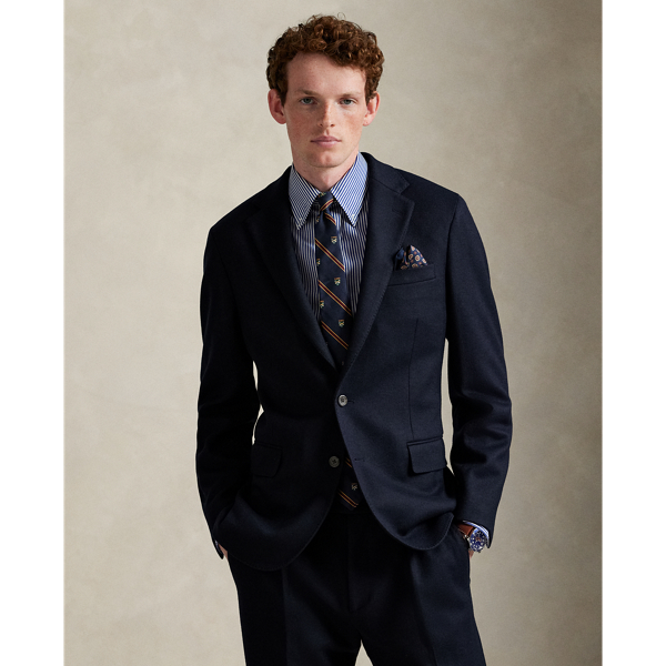 Our Polo Soft suit jacket puts a modern spin on classic preppy style with a natural shoulder, a slightly structured chest and a partial lining. This version is expertly tailored from a knit interpretation of woven flannel, which provides inherent stretch and an elegant drape. The custom-developed cloth features wool and cotton, ensuring that it is both breathable and warm.