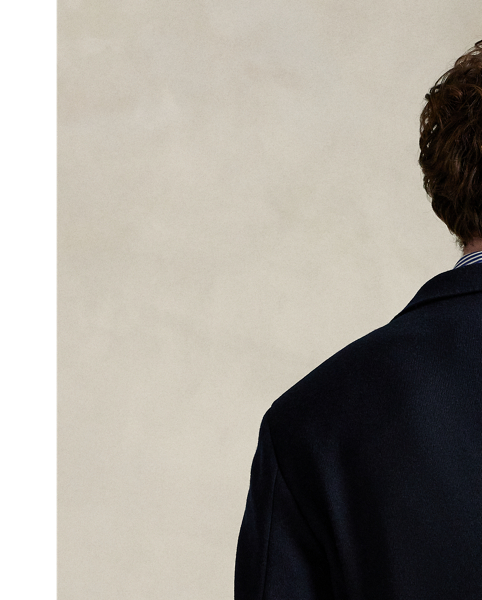 Our Polo Soft suit jacket puts a modern spin on classic preppy style with a natural shoulder, a slightly structured chest and a partial lining. This version is expertly tailored from a knit interpretation of woven flannel, which provides inherent stretch and an elegant drape. The custom-developed cloth features wool and cotton, ensuring that it is both breathable and warm.