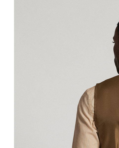 Made with checked wool tweed that was custom-developed with an Italian mill. Fibre-dyed mélange fabric features an open-weave construction. Adjustable buckled back. fully lined. Corozo buttons.