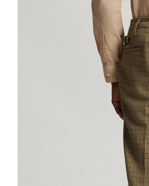 Trim-fitting trousers with a straight leg. Checked wool tweed was custom-developed with an Italian mill. Fibre-dyed mélange fabric features an open-weave construction. Lined to the knees. Side adjusters. Corozo buttons.