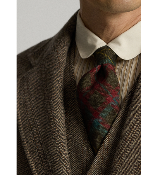 Notch-lapel sport coat. Wool-and-cotton herringbone twill was custom-developed with a storied British mill. Yarn-dyed stripe pattern. half-lined. Corozo buttons.