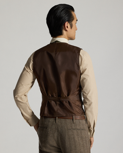 Made from wool-and-cotton herringbone twill custom-developed with a storied British mill. Yarn-dyed stripe pattern. Adjustable buckled back. Fully lined. Corozo buttons.