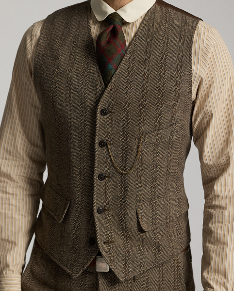 Made from wool-and-cotton herringbone twill custom-developed with a storied British mill. Yarn-dyed stripe pattern. Adjustable buckled back. Fully lined. Corozo buttons.