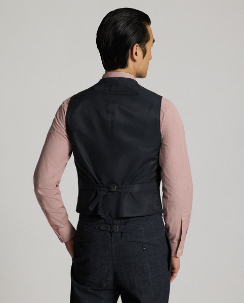 Classic waistcoat tailored in Italy from Japanese herringbone cloth dyed with true indigo. Subtle micro-check pattern is over-printed with a windowpane motif. Adjustable buckled back. Fully lined.