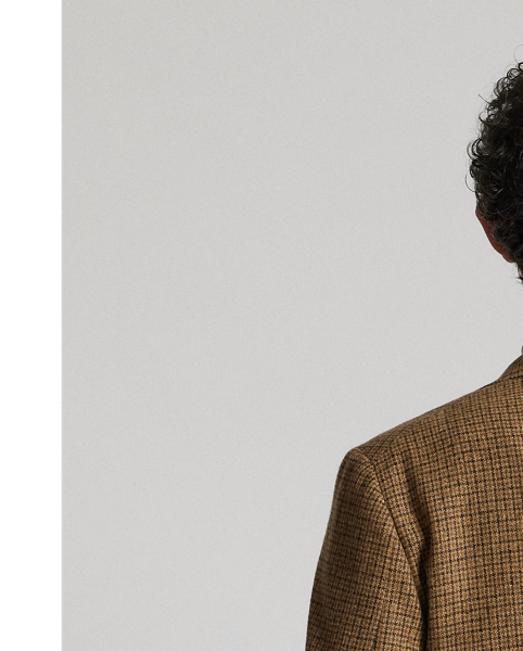 Notch-lapel jacket tailored in Italy. Checked wool cloth was custom-developed with a storied Irish mill. Suede elbow patches. Buttoned throat latch. Half-lined. Genuine horn buttons.