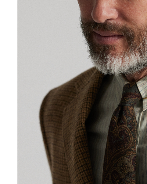 Notch-lapel jacket tailored in Italy. Checked wool cloth was custom-developed with a storied Irish mill. Suede elbow patches. Buttoned throat latch. Half-lined. Genuine horn buttons.