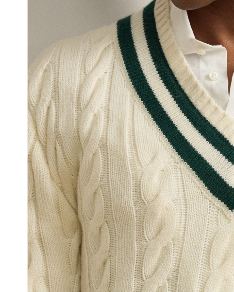The cricket jumper is defined by its cable-knit pattern, usually in cream, as well as its V-neck and striped trim.  Ralph Lauren Lauren introduced his version in 1972 and this Purple Label rendition elevates the iconic characteristics with thick-gauge cashmere yarns and expert Italian crafting.