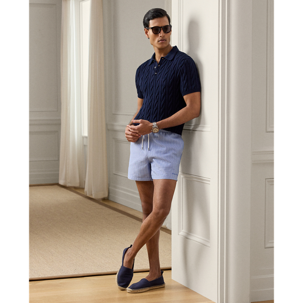 Defined by their relaxed silhouette, these swimming trunks are crafted in Italy with a stretch fabric that is also used for their travel pouch. They feature shirting-inspired stripes and " Ralph Lauren Lauren" script embroidery.