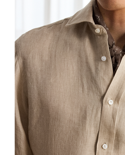 Masterfully crafted in Italy, this shirt imparts an elegant ease with its luxuriously lightweight linen and tick-weave construction. The distinguished design features a bespoke hue and is beautifully finished with genuine mother-of-pearl buttons, showcasing Purple Label's dedication to sartorial excellence.